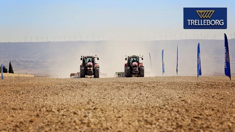 In a crop field, two tractors with Trelleborg tires drive through